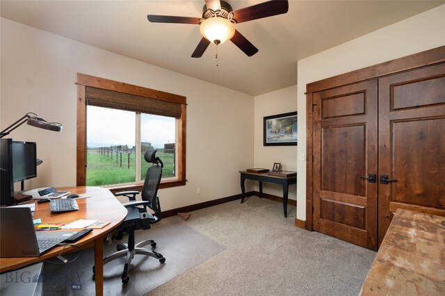 carpeted office featuring ceiling fan