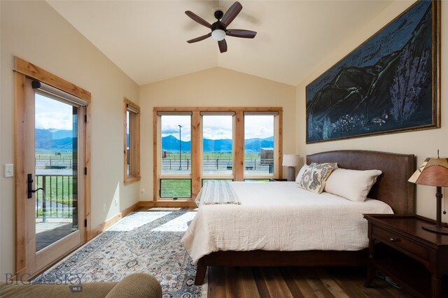 bedroom featuring hardwood / wood-style floors, lofted ceiling, multiple windows, and access to exterior