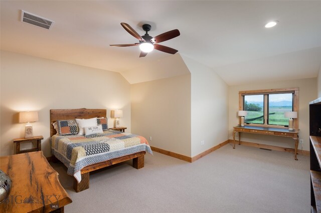 carpeted bedroom featuring ceiling fan and vaulted ceiling