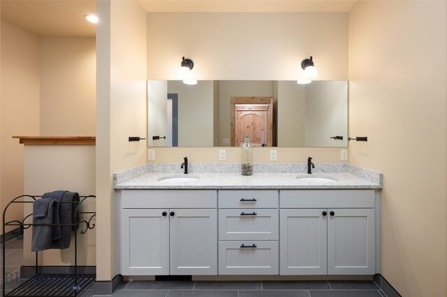 bathroom with dual bowl vanity and tile floors