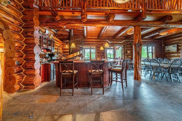 bar with log walls, beamed ceiling, and tile flooring