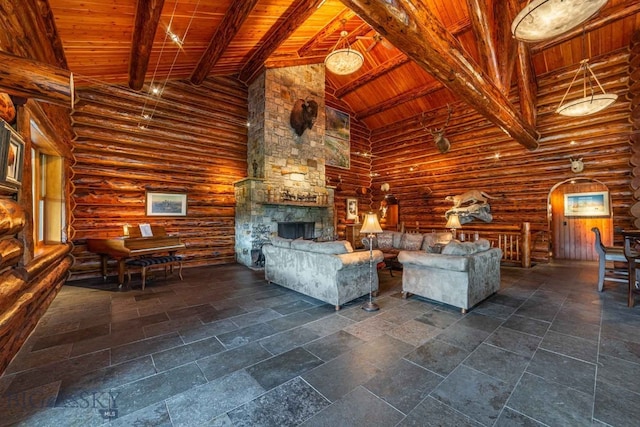 unfurnished living room featuring high vaulted ceiling, rustic walls, beam ceiling, wood ceiling, and a stone fireplace