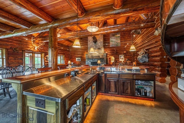 kitchen with beam ceiling, wooden ceiling, a fireplace, log walls, and dark tile floors