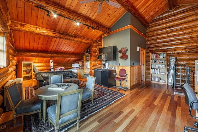 interior space with wood ceiling, hardwood / wood-style flooring, log walls, and beam ceiling