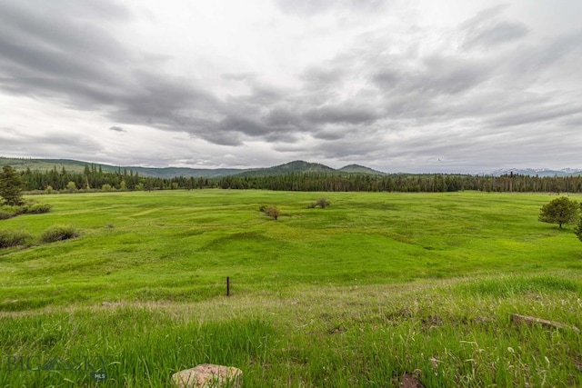 view of mother earth's splendor featuring a rural view and a mountain view