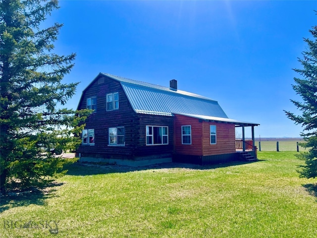 back of property with a lawn