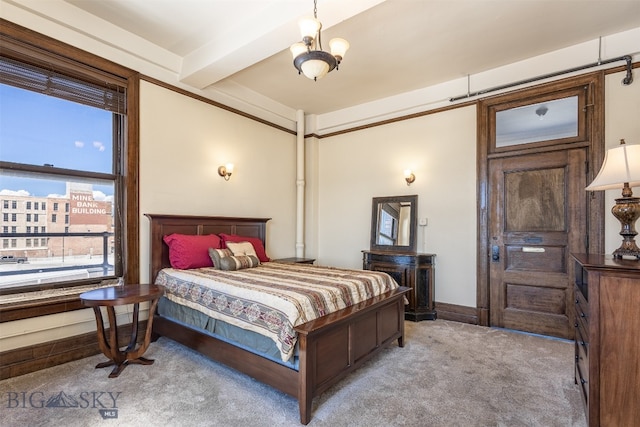 carpeted bedroom featuring a chandelier