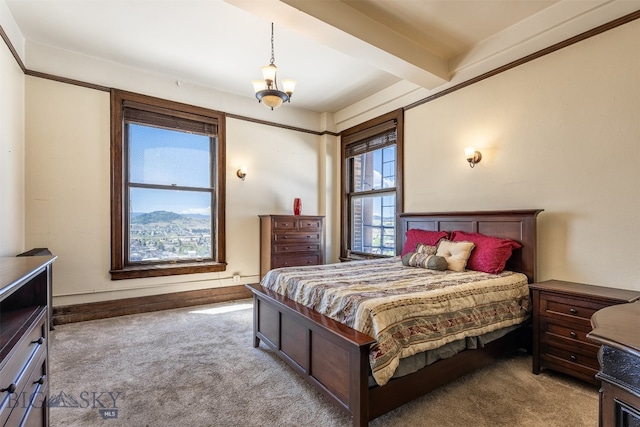 bedroom featuring beam ceiling, a notable chandelier, and carpet floors