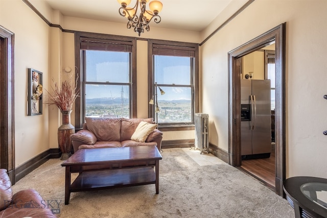 living room featuring carpet flooring, an inviting chandelier, and radiator