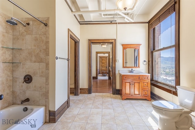 full bathroom with tile flooring, crown molding, tiled shower / bath, toilet, and vanity