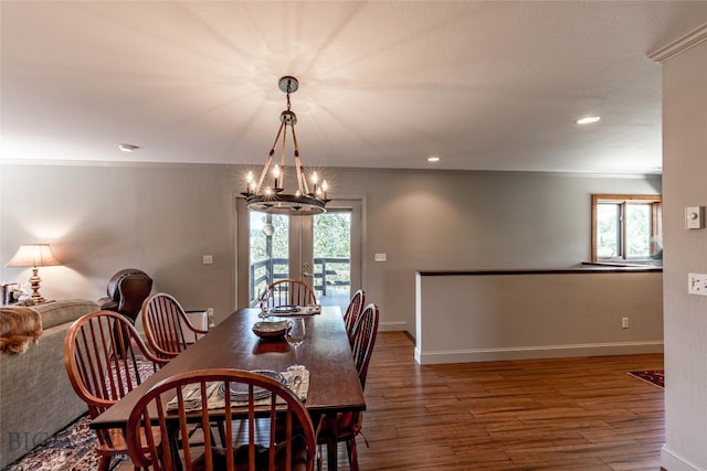 dining room featuring a notable chandelier, french doors, a wealth of natural light, and dark wood-type flooring