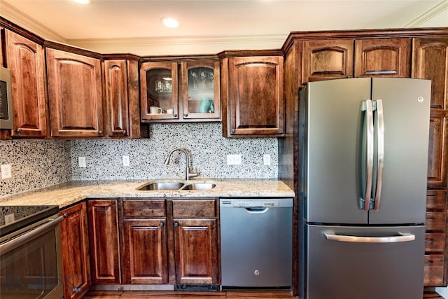 kitchen featuring sink, appliances with stainless steel finishes, tasteful backsplash, and light stone counters