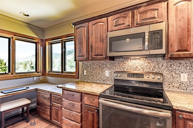 kitchen with tasteful backsplash, light wood-type flooring, stainless steel appliances, and light stone countertops