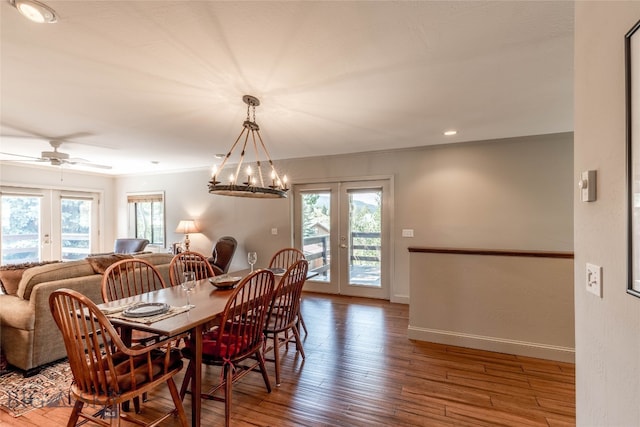 dining area with french doors, plenty of natural light, and wood-type flooring