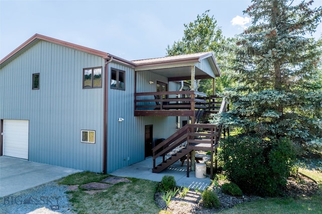 view of side of property featuring a wooden deck and a garage