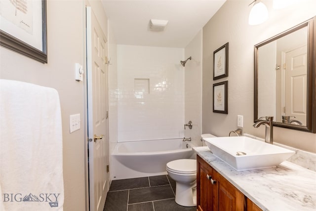 full bathroom with tile flooring, tiled shower / bath, vanity, and toilet