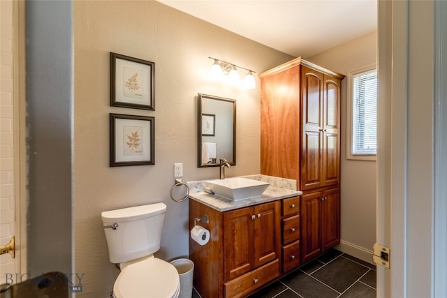 bathroom featuring tile floors, toilet, and vanity with extensive cabinet space