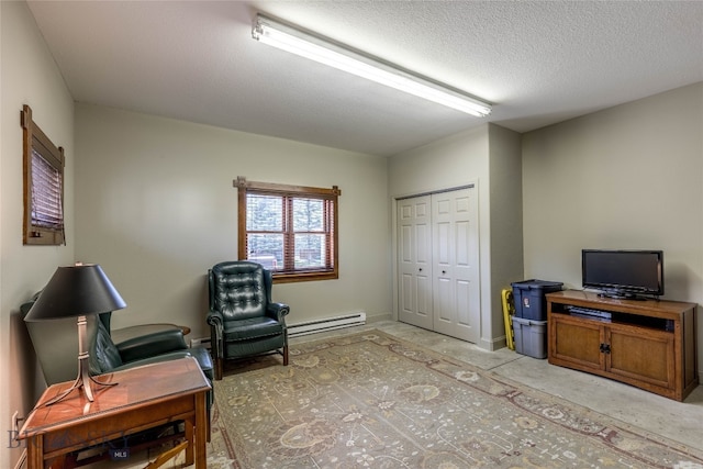 living area featuring concrete flooring, a textured ceiling, and a baseboard radiator