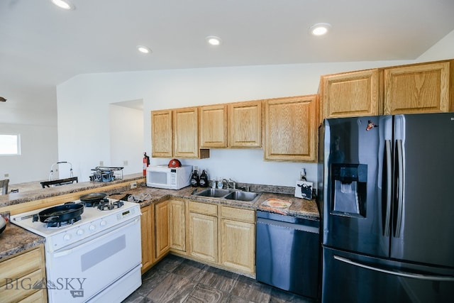 kitchen with lofted ceiling, white appliances, kitchen peninsula, and sink