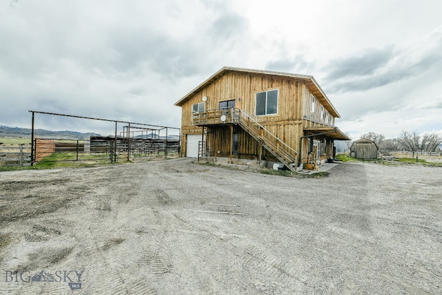 exterior space featuring a rural view and an outdoor structure