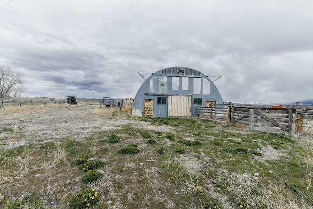 exterior space featuring a rural view and an outdoor structure