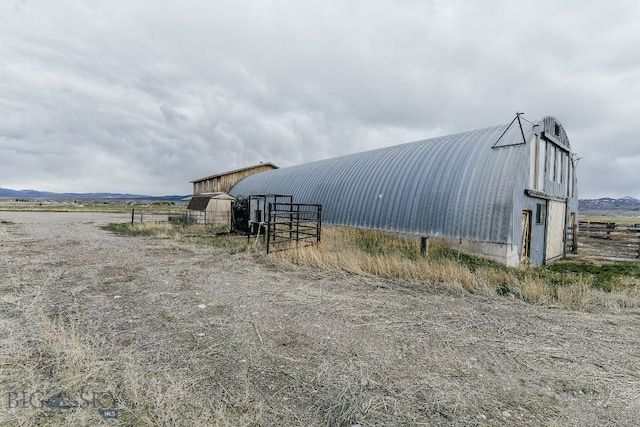 view of shed / structure featuring a rural view