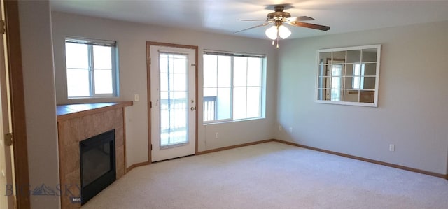 entryway featuring ceiling fan, a healthy amount of sunlight, and light carpet