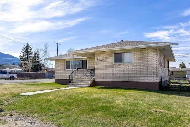 rear view of property with a yard