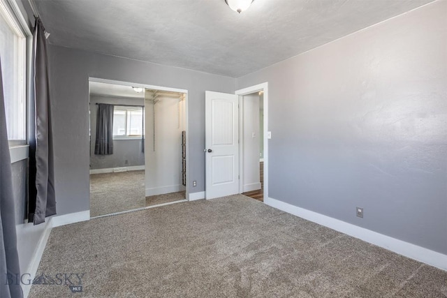 unfurnished bedroom featuring carpet and a closet