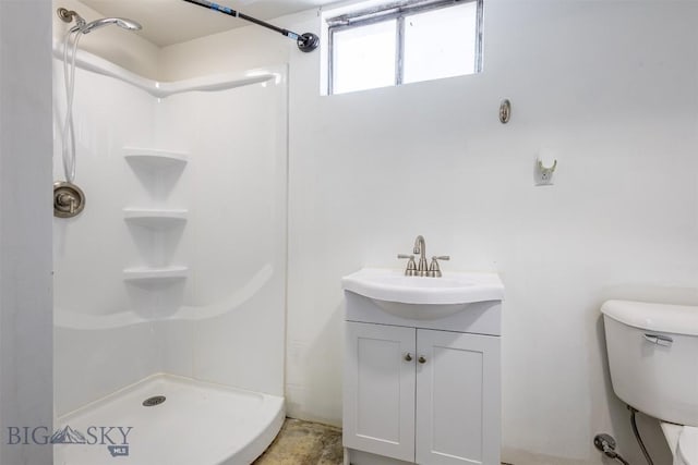 bathroom featuring vanity, toilet, and walk in shower