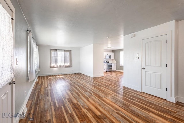 unfurnished living room with hardwood / wood-style floors