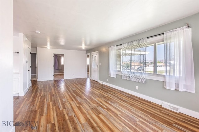 unfurnished living room with hardwood / wood-style floors