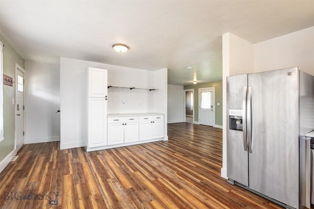 kitchen with white cabinetry, dark hardwood / wood-style flooring, and stainless steel fridge with ice dispenser