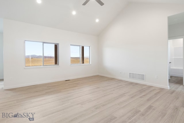 unfurnished room featuring lofted ceiling, ceiling fan, and light wood-type flooring