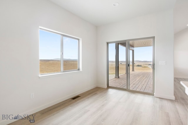 empty room with light hardwood / wood-style floors