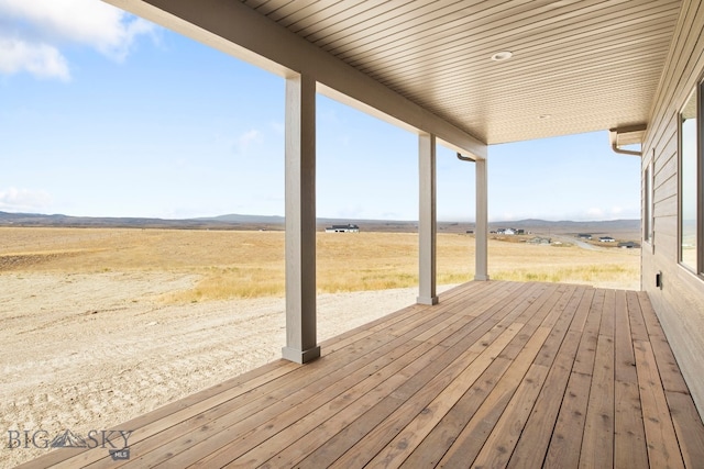 wooden deck with a rural view