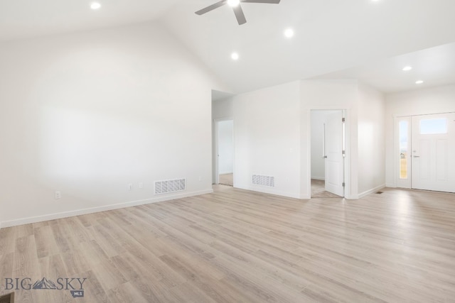 spare room featuring high vaulted ceiling, ceiling fan, and light wood-type flooring