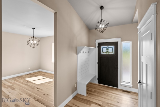 entryway with a chandelier and light hardwood / wood-style flooring