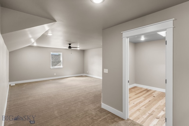 bonus room featuring ceiling fan, light colored carpet, and vaulted ceiling