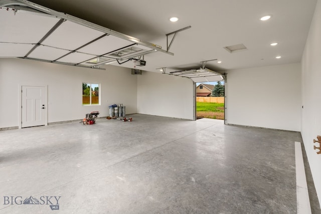 garage featuring a garage door opener and recessed lighting