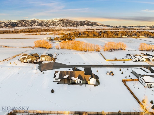 snowy aerial view with a mountain view