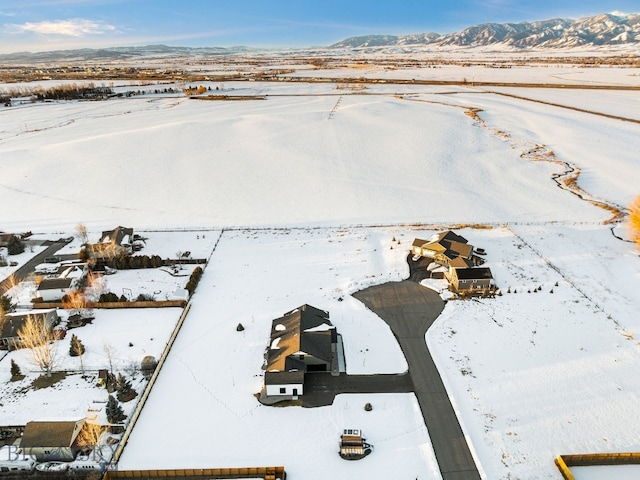 snowy aerial view with a mountain view