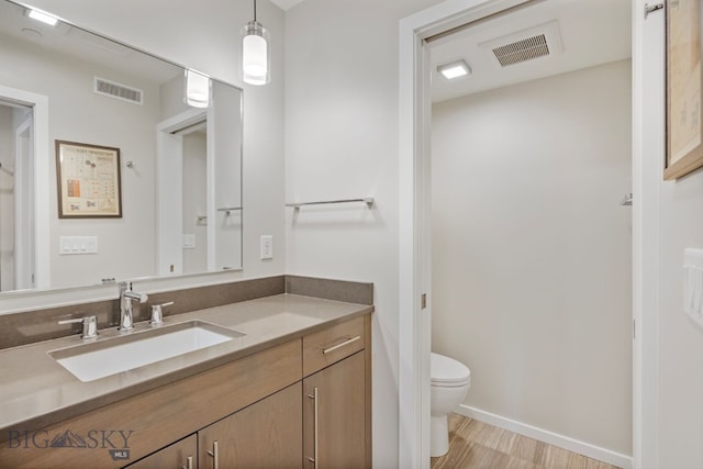 bathroom featuring toilet and vanity