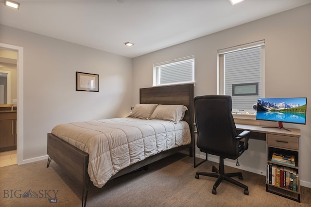 carpeted bedroom featuring ensuite bath