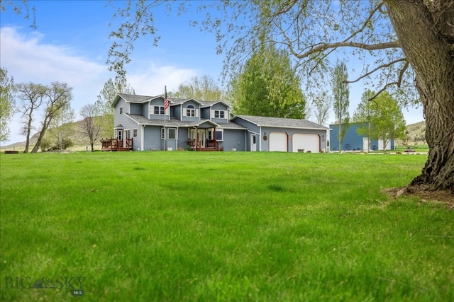 view of front of house featuring a garage and a front lawn