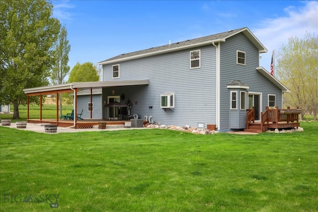 rear view of house featuring a wooden deck, central air condition unit, and a lawn