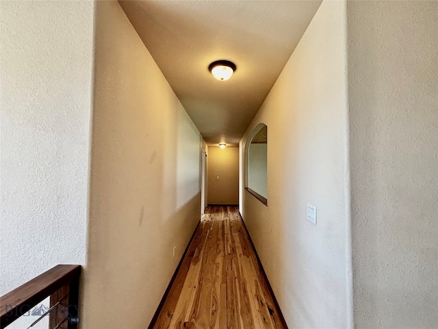 hall with hardwood / wood-style flooring