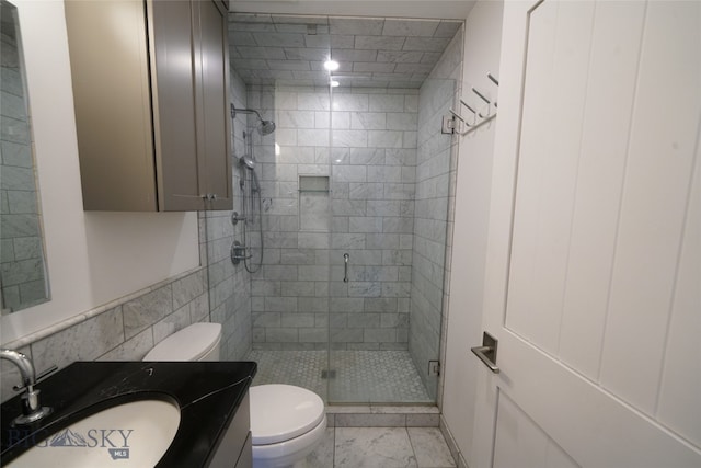 bathroom with vanity, toilet, and a shower with shower door