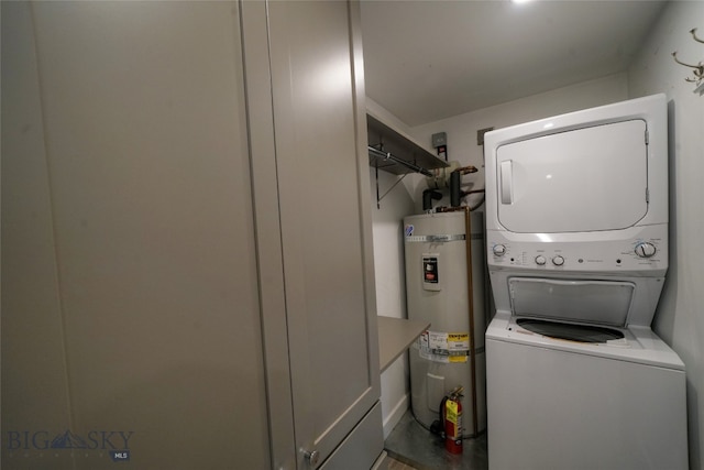 washroom with water heater and stacked washer and clothes dryer