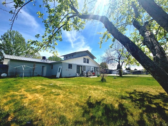 back of property featuring a yard